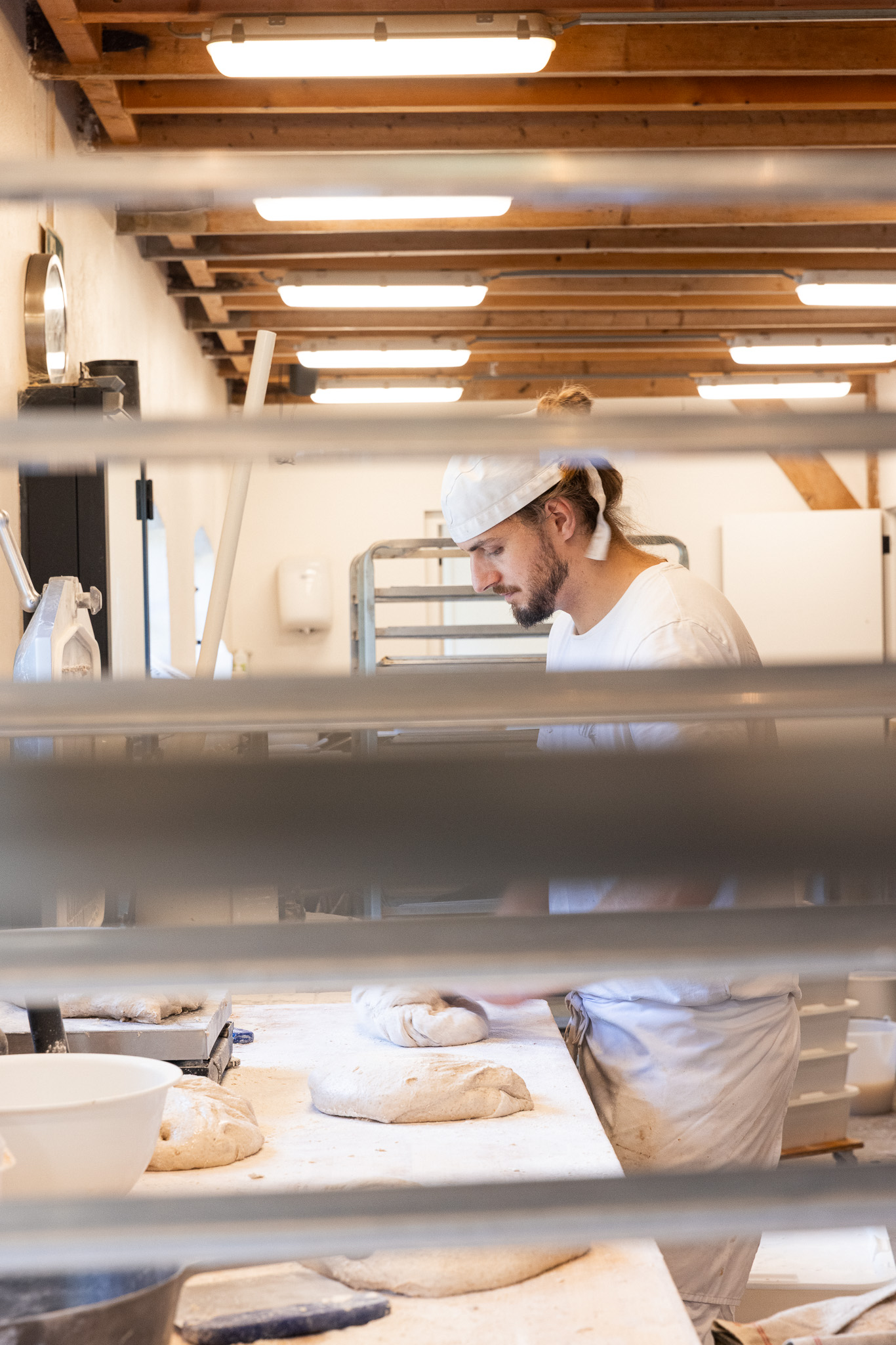 Baker seen through metal shelves